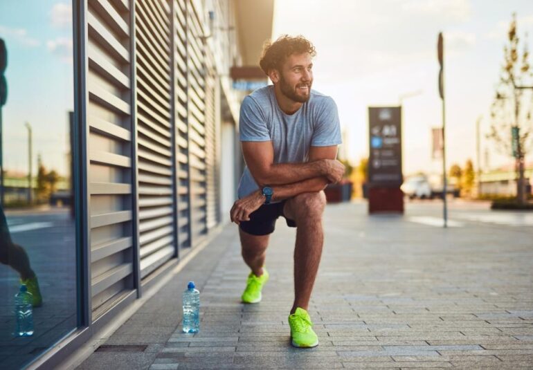 young man exercising / stretching in urban area.